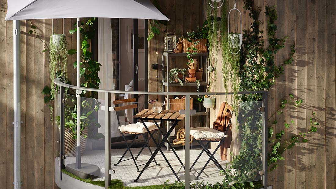 IKEA - Balcony plants and warm wood bring cosiness to this small outdoor space