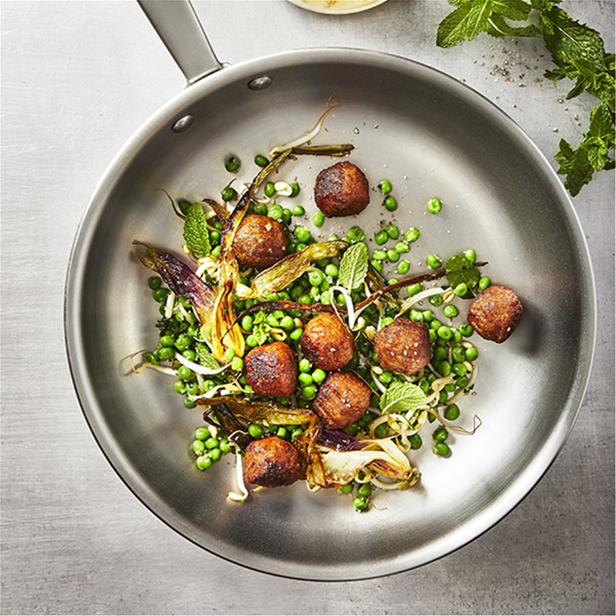 Plant balls with green peas, roasted spring onions, mint and a tahini sauce