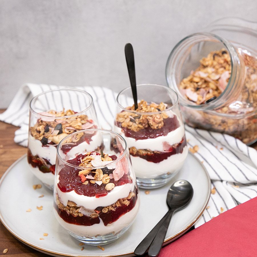 Yoghurt parfait with granola with nuts, dried berries, and lingonberry jam
